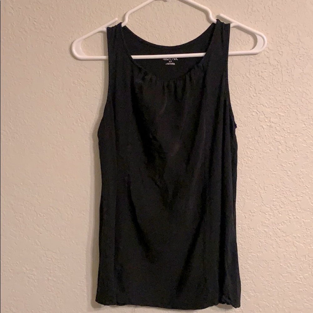 Black sleeveless top.
